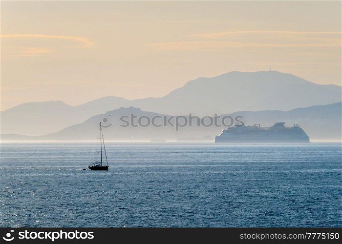 Cruise liner ship and yacht silhouette in Mediterranea sea. Aegean sea, Greece. Cruise liner ship in Mediterranea sea