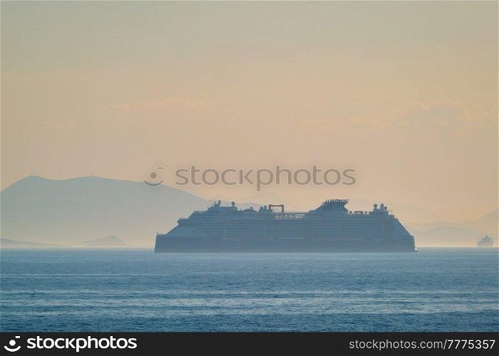 Cruise liner ship silhouette in Mediterranea sea. Aegean sea, Greece. Cruise liner ship in Mediterranea sea