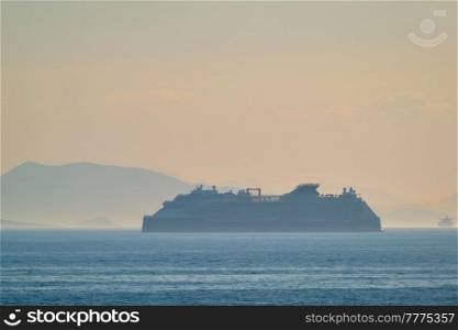 Cruise liner ship silhouette in Mediterranea sea. Aegean sea, Greece. Cruise liner ship in Mediterranea sea