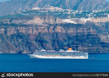 Cruise liner ship vessel in Aegean sea near Santorini island in Greece. Cruise liner ship vessel in Aegean sea near Santorini island. Oia Fira village Santorini, Greece