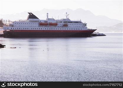 cruise service vessel and mountains on the background. Norway.