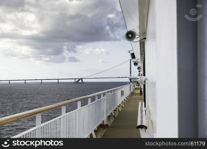 cruise ship crossing the great belt bridge at denmark at the danish islands