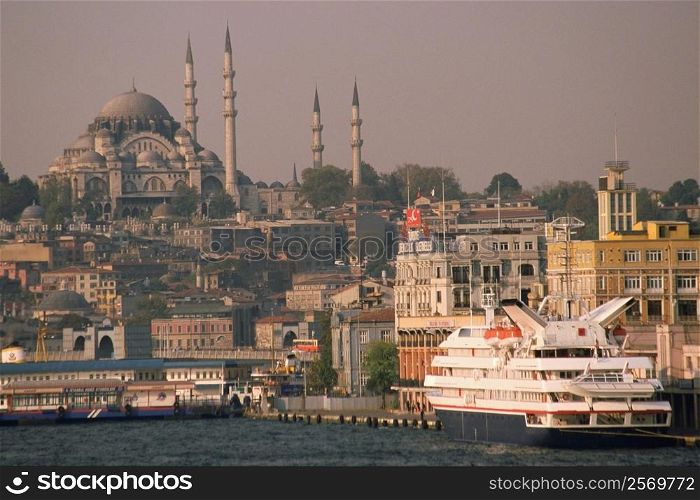 Cruise ship docked at the harbor with a mosque in the background, Suleymanie Mosque, Golden Horn, Istanbul, Turkey