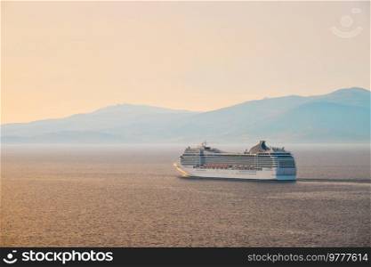 Cruise ship in Aegean sea on sunset. Mykonos island, Greece. Cruise ship in Aegean sea on sunset