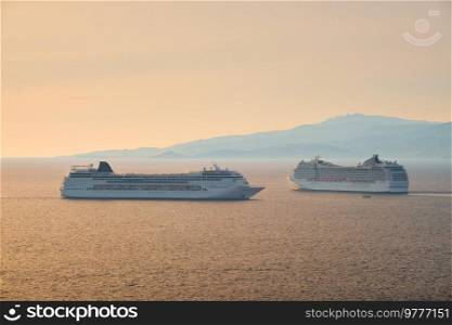 Cruise ships in Aegean sea on sunset. Mykonos island, Greece. Cruise ships in Aegean sea on sunset
