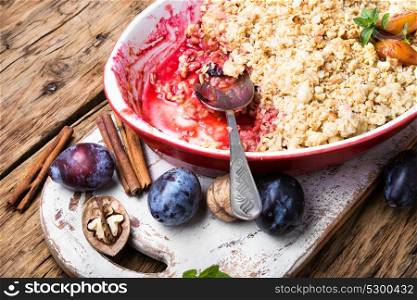 crumble dessert with plum. traditional pie crumb pastry with a plum