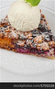 Crumble pie with black currants. English dessert with creamy ice cream. Crumble pie with black currants
