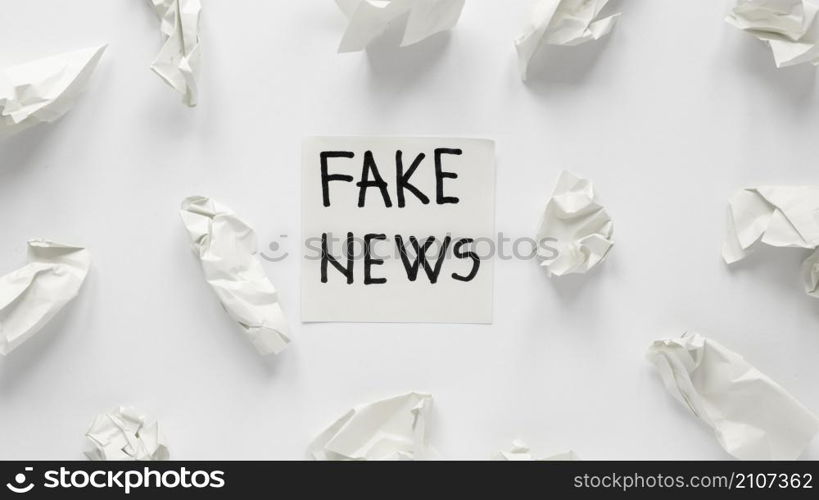 crumbled paper with fake news message
