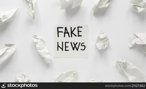 crumbled paper with fake news message