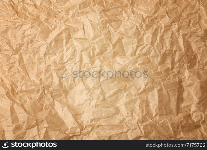 crumpled brown baking parchment paper, full frame, close up