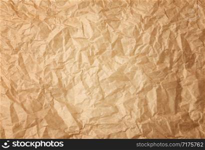 crumpled brown baking parchment paper, full frame, close up