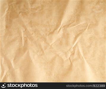 crumpled brown parchment baking paper, full frame, close up