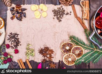 crumpled brown sheet of paper and spices: ginger, cinnamon, cloves, cardamom, star anise, sugar, empty space in the middle