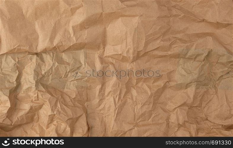 crumpled brown sheet of paper, full frame, close up
