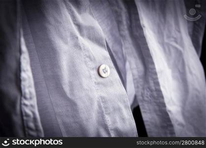 Crumpled, creased un-ironed business shirt and buttons