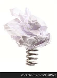 Crumpled paper ball on metal spring isolated on white background