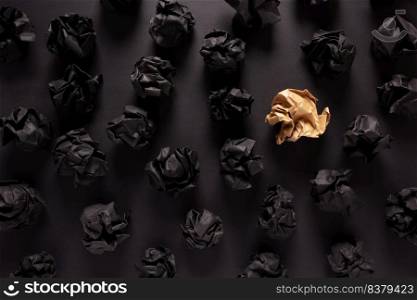 Crumpled paper balls at black background texture. Inspiration creative idea concept