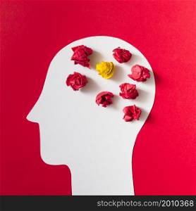 crumpled paper cut out white human head red background