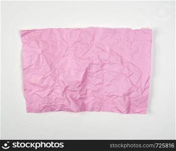 crumpled pink rectangular sheet of paper on a white background, copy space