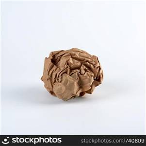 crumpled sheet of brown paper on a white background, close up