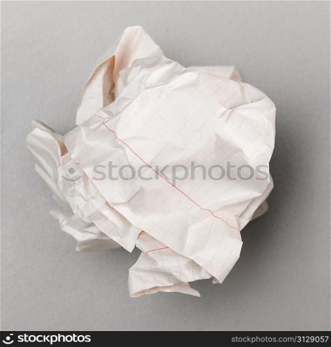 crumpled wad on gray, top view