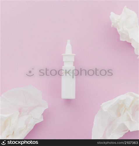 crumpled white paper dropper bottle pink background