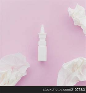 crumpled white paper dropper bottle pink background