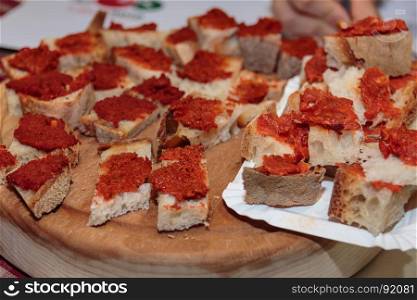 Crunchy Bread Slices with Tomato Sauce, Italian Snack on Wooden Board