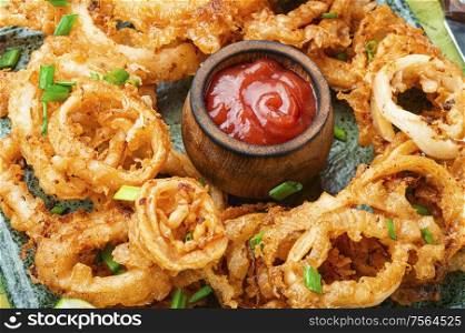 Crunchy deep fried squid rings in batter.Fast food. Fried squid rings breaded