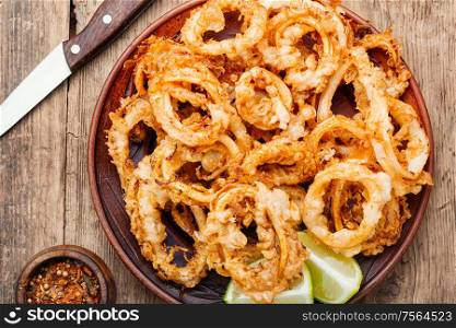 Crunchy deep fried squid rings in batter. Fried squid rings breaded
