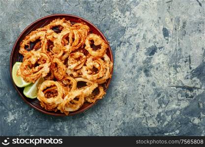 Crunchy deep fried squid rings in batter. Fried squid rings breaded
