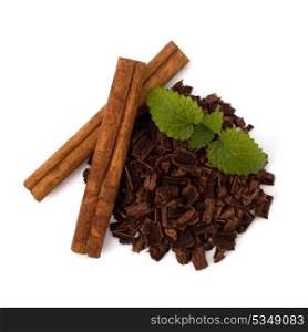 Crushed chocolate shavings pile and cinnamon sticks isolated on white background