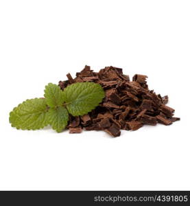 Crushed chocolate shavings pile and mint leaf isolated on white background