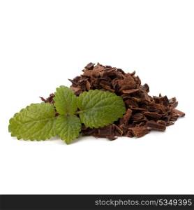 Crushed chocolate shavings pile and mint leaf isolated on white background