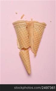 Crushed ice cream waffle cone on pink pastel background
