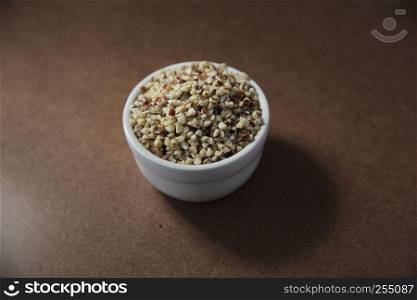 crushed peanuts on wood background in mystic light