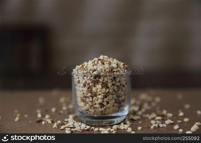crushed peanuts on wood background in mystic light