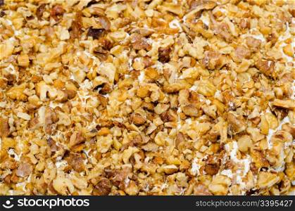 crushed walnuts on cream - cake topping, closeup
