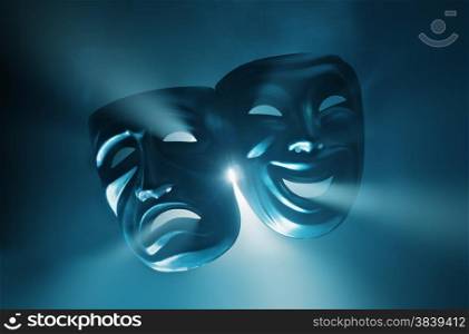Crying and smiling masks in hazy light.