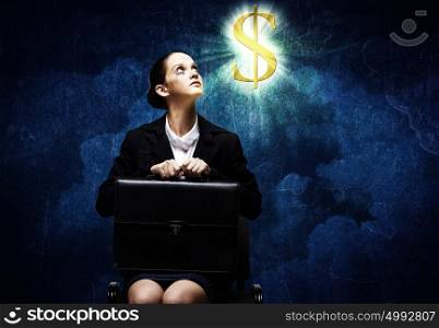 Crying businesswoman. Upset businesswoman sitting on chair with suitcase in hands