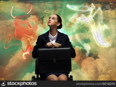 Crying businesswoman. Upset businesswoman sitting on chair with suitcase in hands