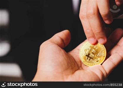 cryptocurrency coins Bitcoin, Women hold the cryptocurrency coin on hand. Money Exchange