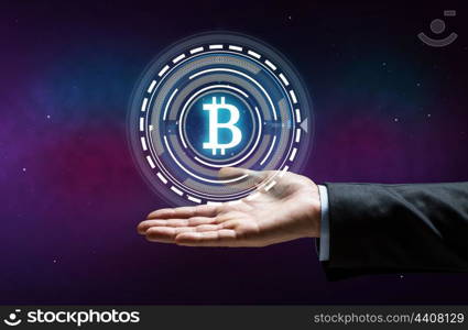 cryptocurrency, finance and business concept - close up of businessman hand with virtual bitcoin symbol hologram over space background. close up of businessman hand with bitcoin hologram. close up of businessman hand with bitcoin hologram