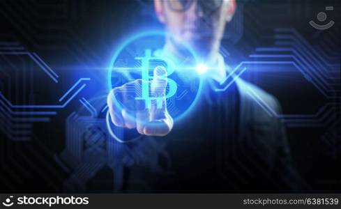 cryptocurrency, finance and business concept - close up of businessman with virtual bitcoin symbol hologram over black background. close up of businessman with bitcoin hologram