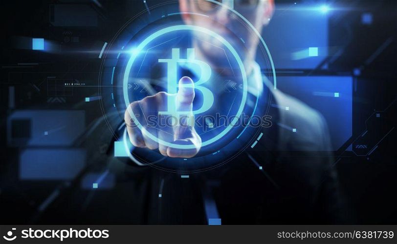 cryptocurrency, finance and business concept - close up of businessman with virtual bitcoin symbol hologram over black background. close up of businessman with bitcoin hologram