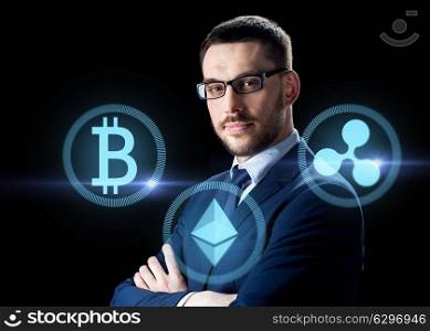 cryptocurrency, financial technology and business concept - buisnessman with virtual bitcoin, ethereum and ripple icons over dark background. buisnessman with cryptocurrency icons. buisnessman with cryptocurrency icons
