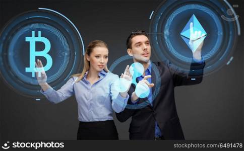 cryptocurrency, financial technology and business concept - businessman and businesswoman working with at virtual bitcoin, ethereum and holograms icons over dark background. businesspeople with cryptocurrency holograms. businesspeople with cryptocurrency holograms