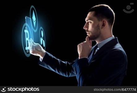cryptocurrency, financial technology and business concept -businessman with transparent tablet pc computer and virtual bitcoin, ethereum and ripple holograms over dark background. businessman with tablet pc and cryptocurrency. businessman with tablet pc and cryptocurrency