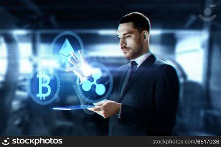 cryptocurrency, financial technology and business concept -businessman with transparent tablet pc computer and virtual bitcoin, ethereum and ripple holograms over abstract background. businessman with tablet pc and cryptocurrency. businessman with tablet pc and cryptocurrency