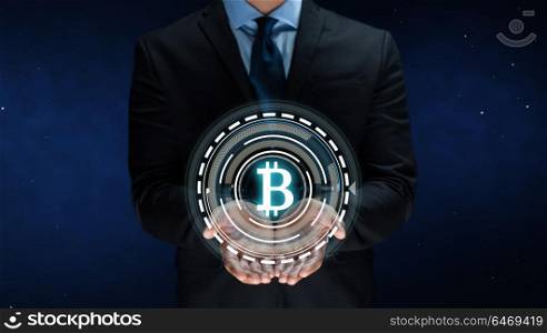 cryptocurrency, financial technology and business concept - close up of businessman with virtual bitcoin symbol hologram over space background. close up of businessman with bitcoin hologram